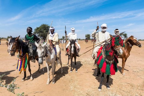 Colourful horse riders at a Tribal festival