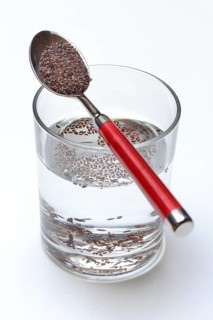Glass of water and spoon with psyllium