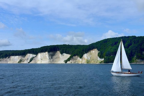 Chalk coast with sailing boat