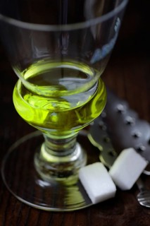 Glass of absinthe with absinthe spoon and sugar cubes
