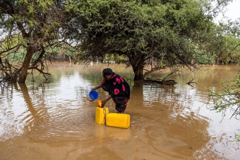 Woman fetches water in canisters