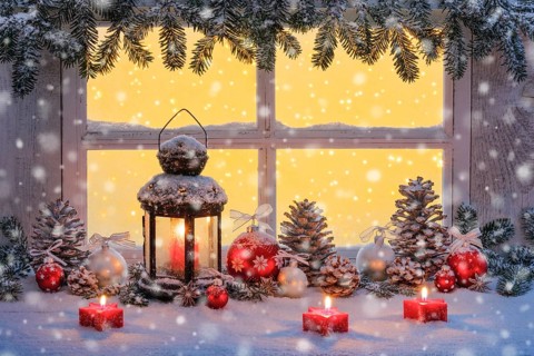Lantern with Christmas decoration on windowsill
