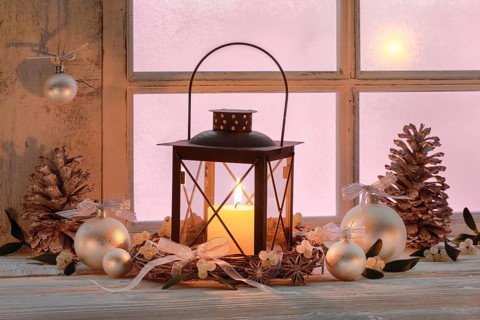 Lantern with Christmas decoration on windowsill
