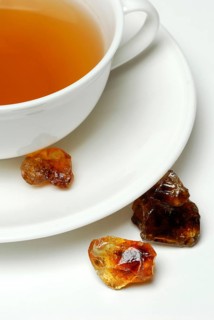 Cup of tea and brown rock candy