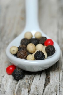 Peppercorns in porcelain spoon