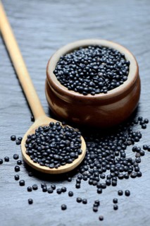 Beluga lentils in cooking spoon