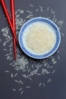 Rice grains in husk and chopsticks