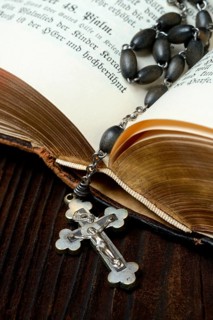 Crucifix and rosary chain on bible
