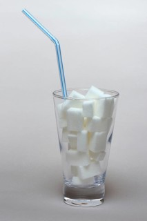 Sugar cubes in drinking glass with straw