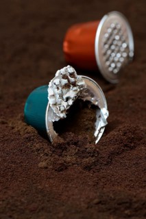 Opened coffee capsule and coffee powder