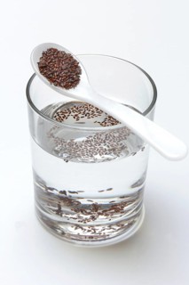 Glass of water and spoon with psyllium