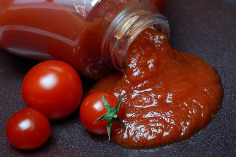 Tomato ketchup flows from bottle