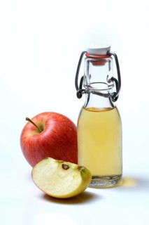 Bottle with apple vinegar and apples