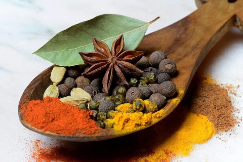 Various spices in wooden spoon