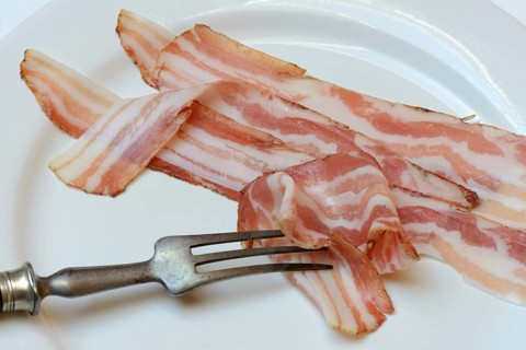 Bacon on plate with fork