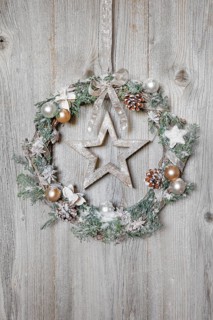 Christmas wreath on wooden wall with star