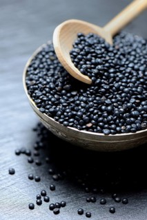 Beluga lentils in cooking spoon