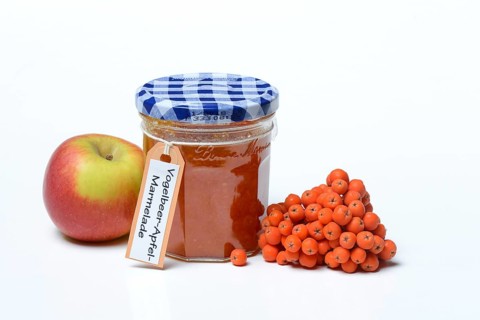 Glass of rowanberry and apple jam with n