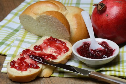Pomegranate jelly on a slice of butter plait