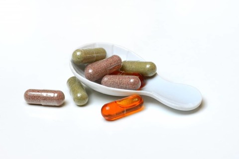 Capsules in porcelain spoon