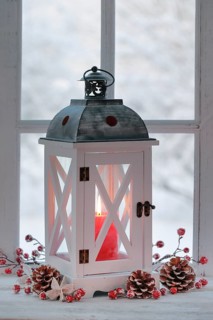 Lantern with Christmas decoration on windowsill