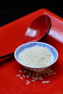 Rice grains in bowls and chopsticks
