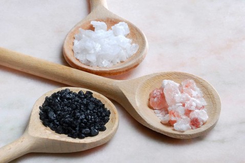Different kinds of salt on wooden spoons