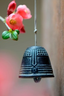 Bell with flower of an ornamental quince