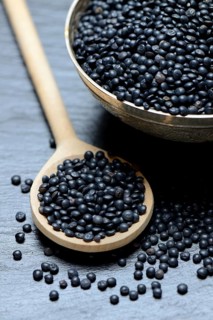 Beluga lentils in cooking spoon