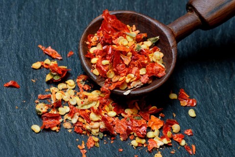 Dried chili peppers with wooden spoon