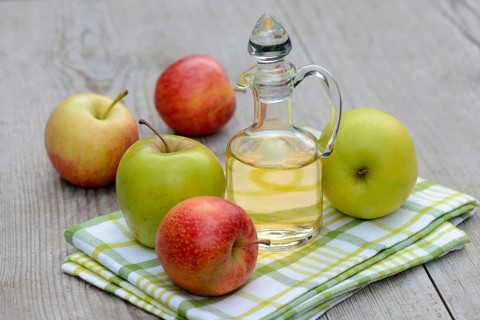 Carafe with apple vinegar and apples