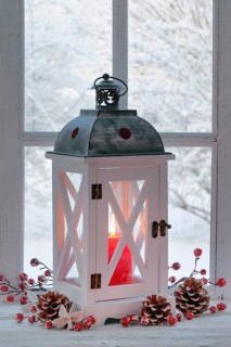 Lantern with Christmas decoration on windowsill