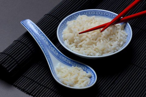Basmati rice in bowl and porcelain spoon