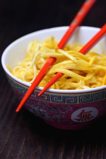 Chinese noodles in bowl with chopsticks