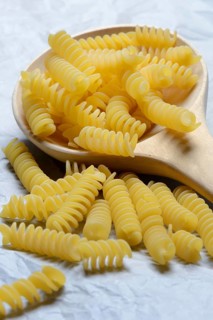 Spiral noodles in wooden ladle
