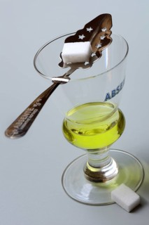 Glass of absinthe with absinthe spoon and sugar cubes