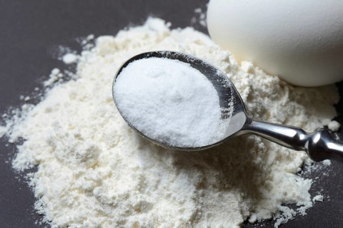 Spoon with baking soda and flour and egg