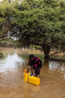 Woman fetches water in canisters