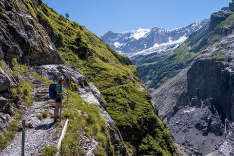 Young woman on hiking trail from Grindelwald to Schreckhornhuette