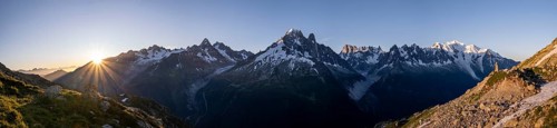 Sun in front of mountains