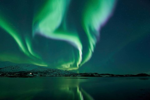 Aurora borealis with water reflection in fjord