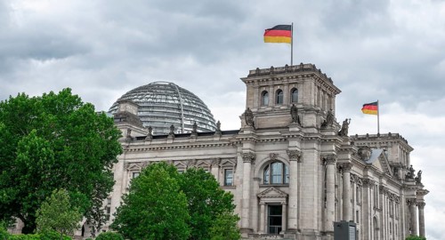 Reichstag building with waving German flag