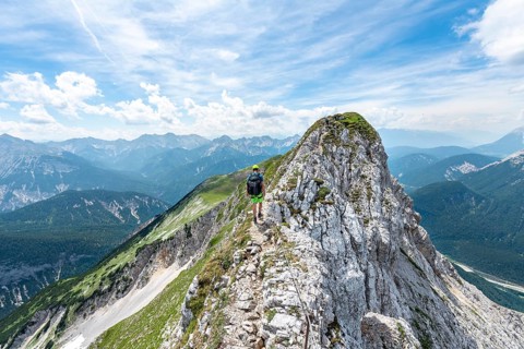 Mountaineer on a ridge on a secured via ferrata