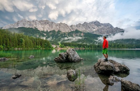 Young man standing on a rock on the shore