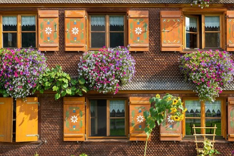 Facade of a Bregenzerwald house with flower decorations