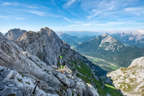 Mountaineer climbs on a secured fixed rope route