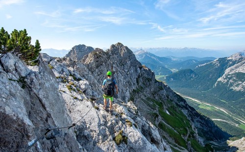 Mountaineer climbs on a secured fixed rope route