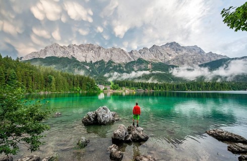 Young man standing on a rock on the shore