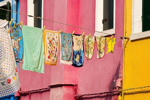 Towels drying on line in front of colorful houses