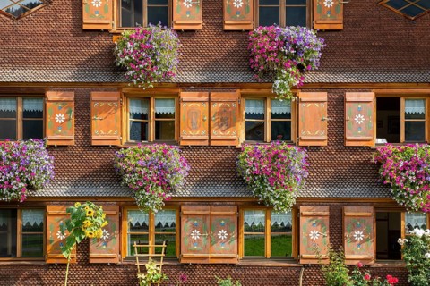 Facade of a Bregenzerwald house with flower decorations